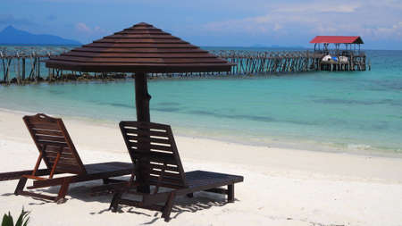 Beach chairs with umbrella and beautiful white sand beach. Panorama of tropical beach with white sand and turquoise water. Travel summer holiday background concept ...の写真素材