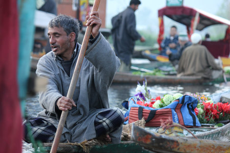 KASHMIR,INDIA- APRIL 19:Atmosphere in the morning at traditional floating vegetable market  where local people buy, sell and sometimes exchange vegetables  in Dal Lake, Srinagar, Kashmir, INDIA on April 19, 2012のeditorial素材