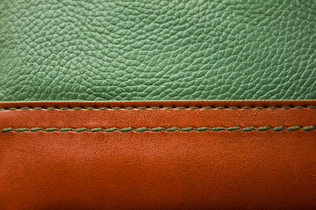 brown and dark green leather texture with green stitchの写真素材