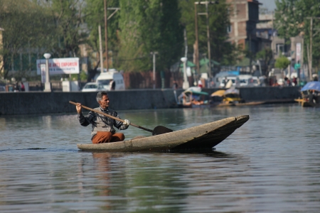 SRINAGAR, INDIA - April 20: Lifestyle in Dal lake,local people use 'Shikara', a small boat for transportation in the lake., April 20, 2012 in Srinagar, Kashmir, Indiaのeditorial素材