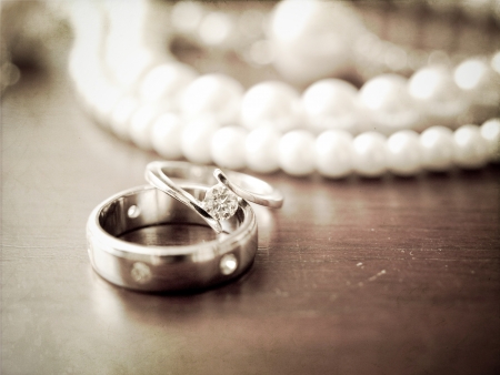  two wedding rings and pearl necklace in vintage sepia backgroundの写真素材