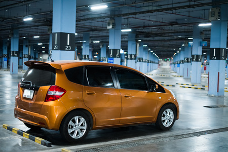 eco car in big empty indoor parking garage at nightのeditorial素材