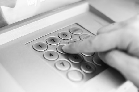hand pressing ATM keyboard