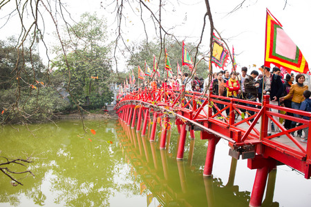 HANOI/VIETNAM-FEB 13: Unidentified tourists visiting Red Bridge in Hoan Kiem Lake, Ha Noi, Vietnam during chinese new year  or TET festival on Feb 14, 2013.のeditorial素材
