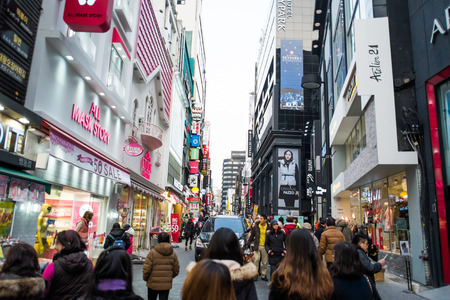 SEOUL, SOUTH KOREA -DECEMBER 7, 2014: Unidentified people at Myeong-Dong district at night. Myeongdong is one of Seoulâs main shopping districts, famous for hi-end fashion outlet, cosmatics and street food.のeditorial素材