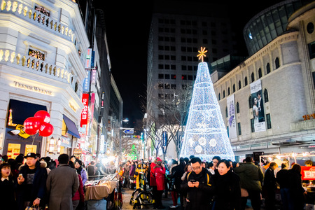 SEOUL, SOUTH KOREA -DECEMBER 7, 2014: Unidentified people at Myeong-Dong district at night. Myeongdong is one of Seouls main shopping districts, famous for hi-end fashion outlet, cosmatics and street food.のeditorial素材