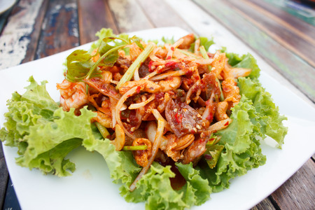 spicy thai salad with herbs - traditional foodの写真素材