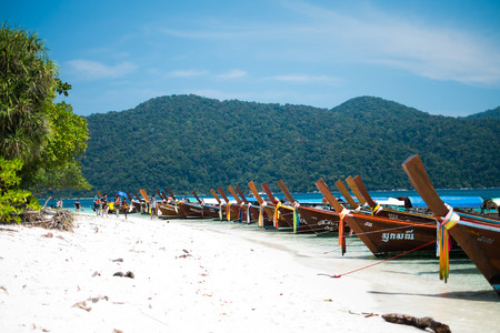 KOH ADANG, THAILAND - FEB 21 Crowded tourists and  a lot of local wooden boats during Chinese New Year 2015 at Adang Island  near Koh Lipe in  the southern of Thailand on February 21, 2015.のeditorial素材