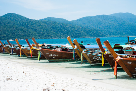 KOH ADANG, THAILAND - FEB 21 Crowded tourists and  a lot of local wooden boats during Chinese New Year 2015 at Adang Island  near Koh Lipe in  the southern of Thailand on February 21, 2015.のeditorial素材