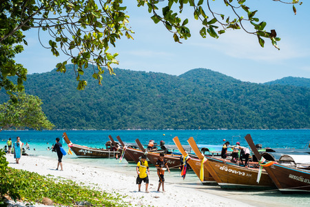 KOH ADANG, THAILAND - FEB 21 Crowded tourists and  a lot of local wooden boats during Chinese New Year 2015 at Adang Island  near Koh Lipe in  the southern of Thailand on February 21, 2015.のeditorial素材