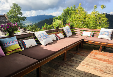 outdoor living room or balcony with pillows with mountain and forest background - home decorationの写真素材