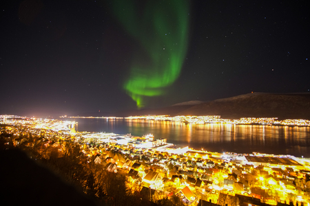 Northern lights (aurora borealis) over Tromso City, Norwayの写真素材