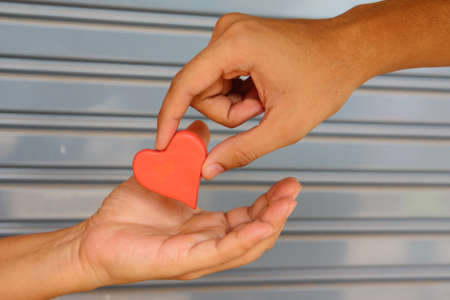 Giving red heart plasticineの写真素材