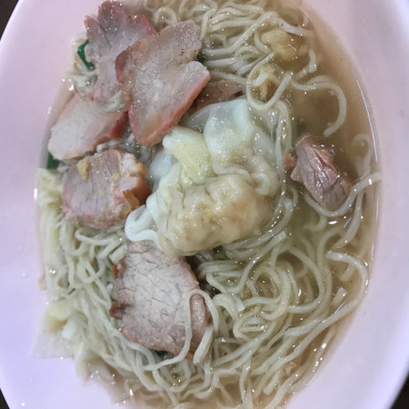Rice noodle soup with pork in white bowl.の写真素材