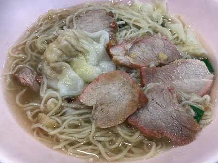 Noodle soup with pork and egg in bowl on the table.の写真素材
