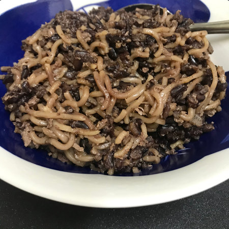 Buckwheat noodles with beef and mushrooms on a blue plateの写真素材