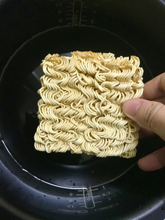 instant noodle in the black bowl, closeup of photo