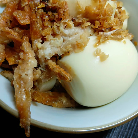 Fried Garlic and Boiled Egg in Ceramic Bowlの写真素材