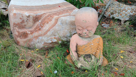 Old Buddha Image and Stone at The Gardenの写真素材