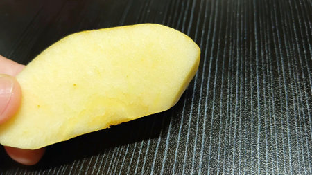 Fresh Apple Slice on Handの写真素材