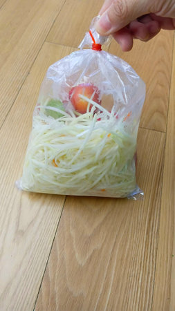 Raw Ingredients in Plastic Bag for Cooking Papaya Saladの写真素材