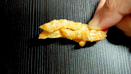Crispy Pork Rinds on Handの写真素材