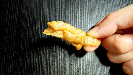 Crispy Pork Rinds on Handの写真素材
