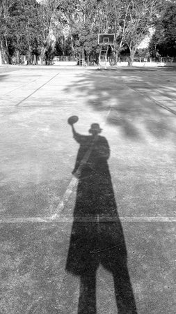 Shadow of Sport Man on Basketball Court as Black and White Toneの写真素材