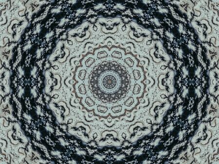 Kaleidoscope of vivid abstract pattern as looking through rough translucent glass. Selective focus.の写真素材