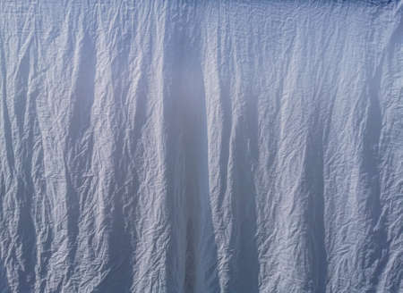 Texture of white fabric under the strong sunlight in a sunny day.の写真素材