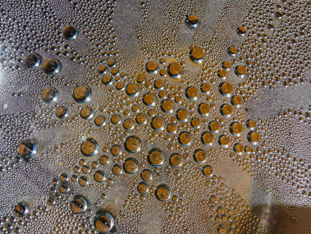 Pattern of water drops under the clear plastic covered over the metal pot. Selective focus.の写真素材