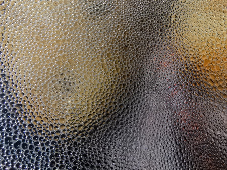 Pattern of water drops under the clear plastic covered over the metal pot.