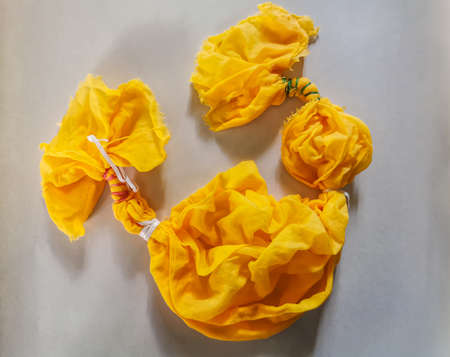 Tie-dye cotton fabric after dyeing with red Saffron, Crocus sativus, threads. Resulting in bright yellow color on dyed fabric.の写真素材