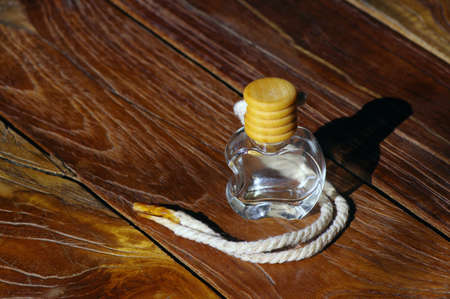 An apple shaped perfume bottle with its shadow. Nature background.の写真素材