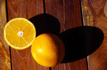 Sweet oranges on the teak wood table. Macro photography.の写真素材