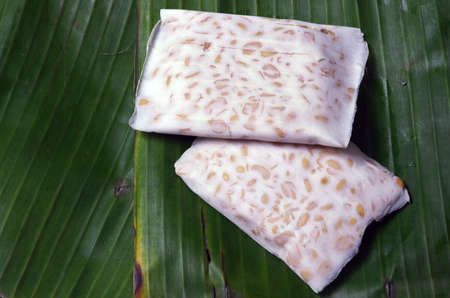 Raw tempe, on banana leaves. Tempe is a traditional Indonesian food made from fermented soybeans.の写真素材