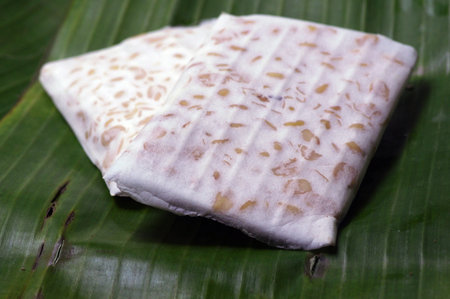 Raw tempe, on banana leaves. Tempe is a traditional Indonesian food made from fermented soybeans.
