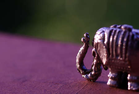 A metal figure of elephant, in beautiful metallic details, with blurred background.の写真素材
