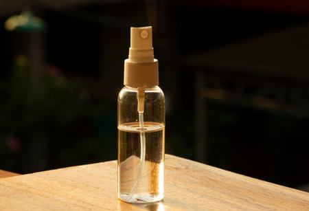 Hand sanitizer in the bottle to wash hands for flu virus prevention concept, with dark blurred background.の写真素材