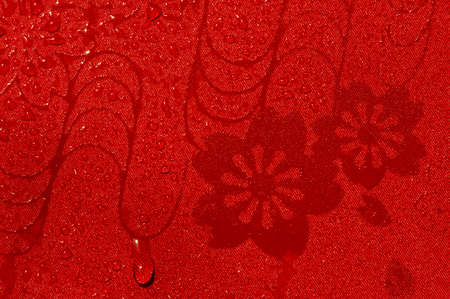 Red floral cloth with water splashesの写真素材