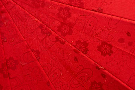 Red floral cloth with water splashesの写真素材