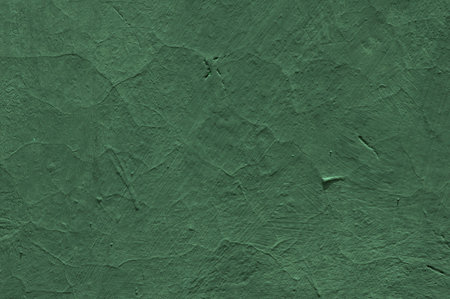 Vintage green concrete wall in shallow focus for interiors, art wallpaper or artistic texture backgroundの写真素材
