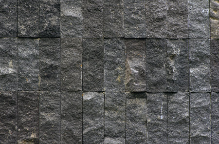 Natural dark plaid stone wall background and backdrop