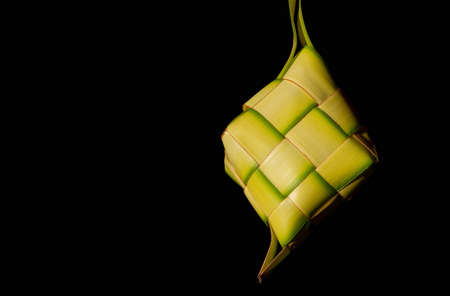 Ketupat Lebaran, a rice cake packed inside a diamond shaped container of woven coconut leaves, served in the end of Ramadan and in Eid Fitr (Eid Mubarak) in Indonesia, Malaysia, Brunei and Singaporeの写真素材