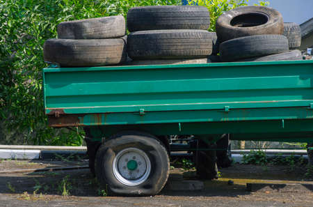 Pile of used tires in a pickup truck with a flat tireの写真素材