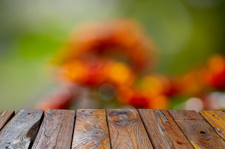 Old teak wood empty table in front of colorful bokeh background for display of product