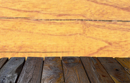 Old teak wood empty table in front of brown wood texture background