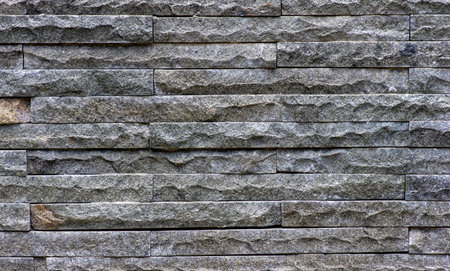 Natural dark plaid stone wall background
