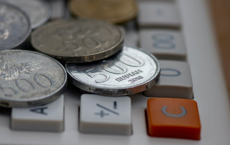 Close up of old Indonesian money rupiah coins on a calculator button, selected focusの写真素材