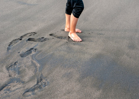 Foot prints on the sandy beach, in Parangtritis Beach, Yogyakarta, Indonesiaの写真素材